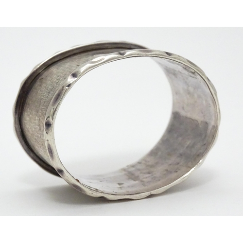 388 - A silver napkin ring hallmarked Birmingham 1929, maker Samuel Levi. Together with a glass caster wit... 