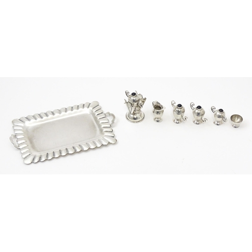 396 - A .925 Mexican silver miniature tray. Together with a white metal miniature / dolls house part tea s... 