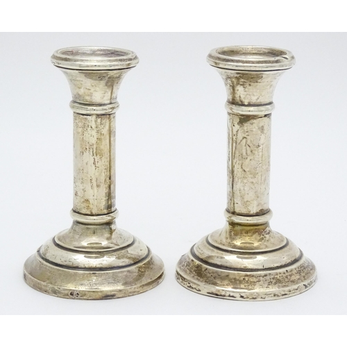 486 - A pair of silver candlesticks hallmarked Birmingham 1926, maker Jones & Crompton. Approx. 4 3/4