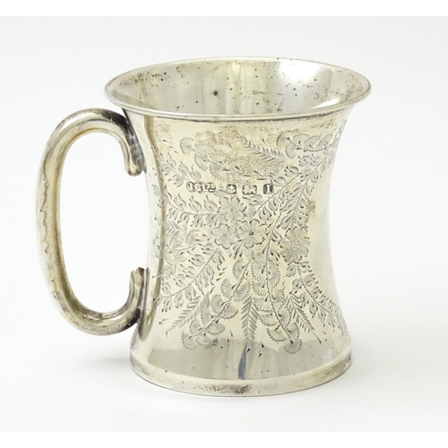 246 - A silver mug with floral and foliate decoration and loop handle.  Hallmarked Birmingham 1910 maker J... 