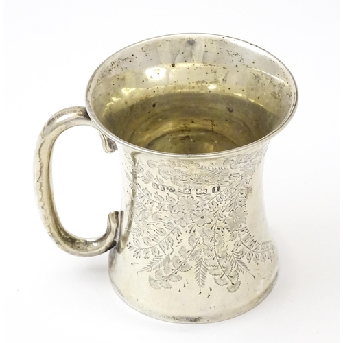 246 - A silver mug with floral and foliate decoration and loop handle.  Hallmarked Birmingham 1910 maker J... 