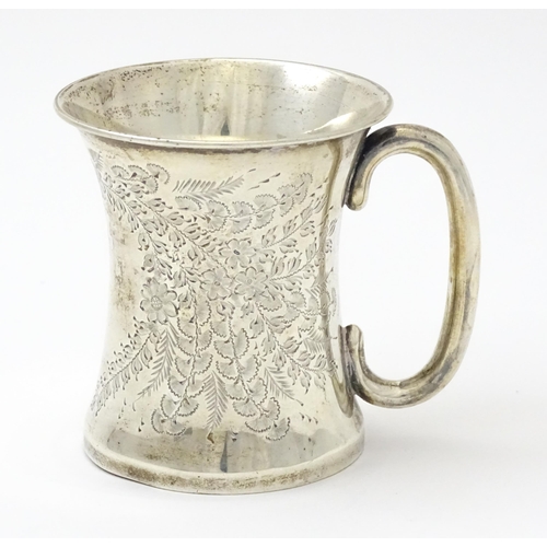 246 - A silver mug with floral and foliate decoration and loop handle.  Hallmarked Birmingham 1910 maker J... 