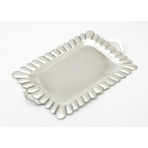 396 - A .925 Mexican silver miniature tray. Together with a white metal miniature / dolls house part tea s... 