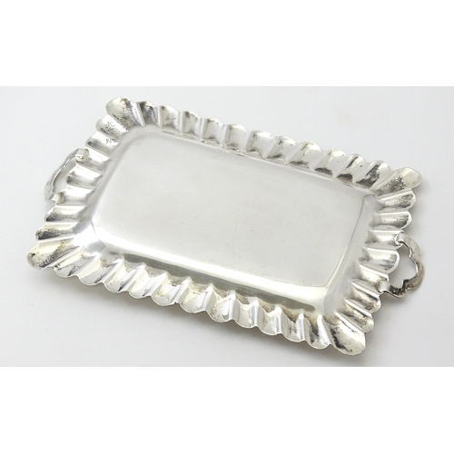 396 - A .925 Mexican silver miniature tray. Together with a white metal miniature / dolls house part tea s... 