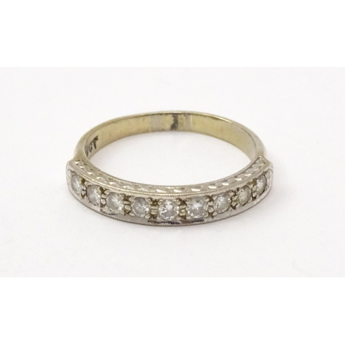 547 - An 18ct white gold half eternity ring set with nine diamonds. Ring size approx. P 1/2