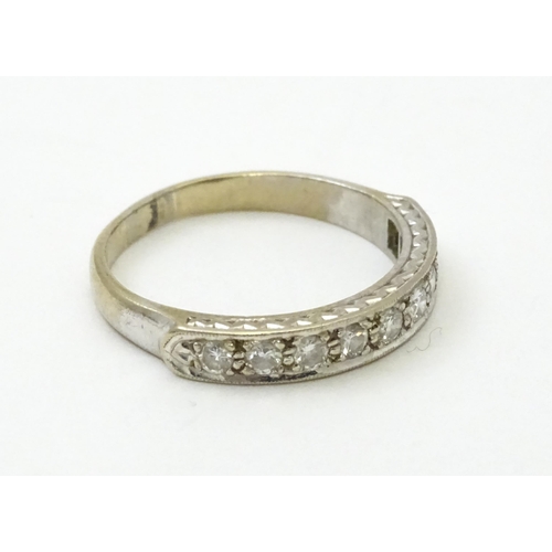 547 - An 18ct white gold half eternity ring set with nine diamonds. Ring size approx. P 1/2