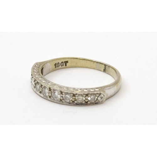 547 - An 18ct white gold half eternity ring set with nine diamonds. Ring size approx. P 1/2