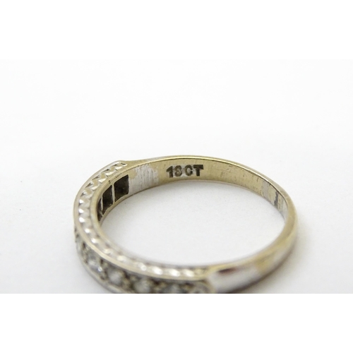 547 - An 18ct white gold half eternity ring set with nine diamonds. Ring size approx. P 1/2