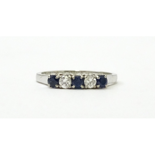 554 - A 14ct white gold ring set with spinel and diamonds in a linear setting. Ring size approx. N 1/2