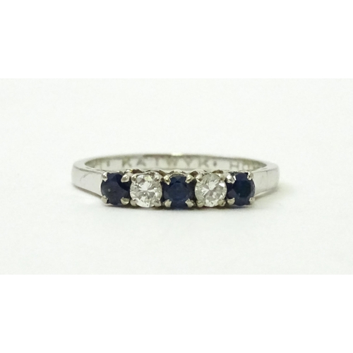 554 - A 14ct white gold ring set with spinel and diamonds in a linear setting. Ring size approx. N 1/2