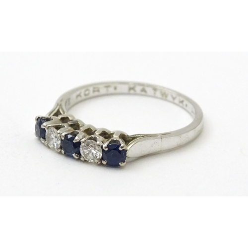 554 - A 14ct white gold ring set with spinel and diamonds in a linear setting. Ring size approx. N 1/2