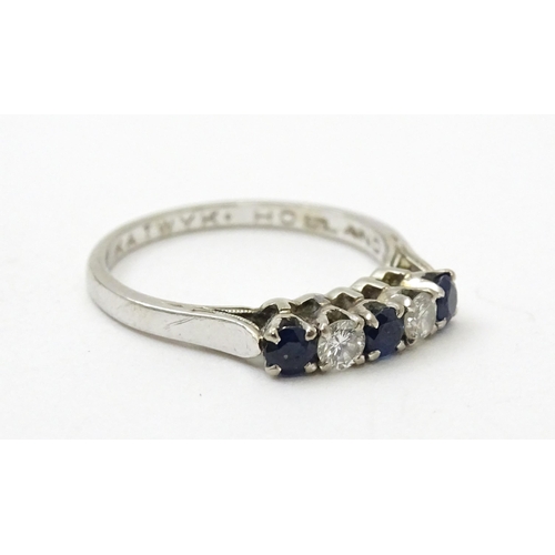 554 - A 14ct white gold ring set with spinel and diamonds in a linear setting. Ring size approx. N 1/2