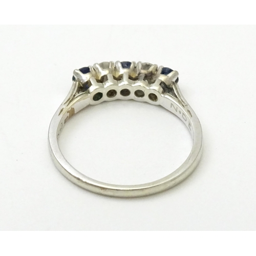 554 - A 14ct white gold ring set with spinel and diamonds in a linear setting. Ring size approx. N 1/2