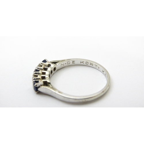 554 - A 14ct white gold ring set with spinel and diamonds in a linear setting. Ring size approx. N 1/2