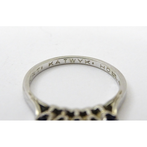 554 - A 14ct white gold ring set with spinel and diamonds in a linear setting. Ring size approx. N 1/2