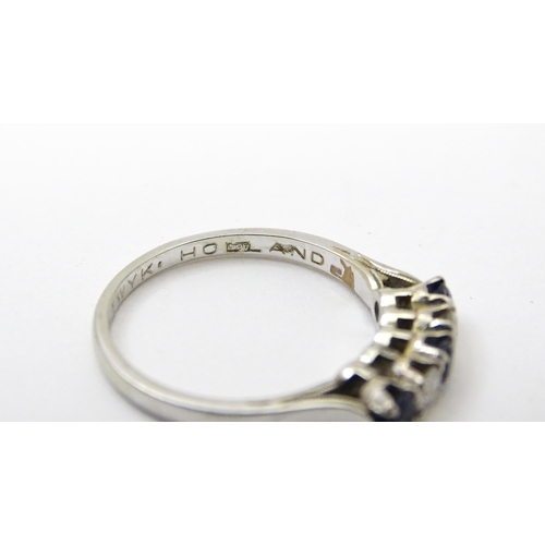 554 - A 14ct white gold ring set with spinel and diamonds in a linear setting. Ring size approx. N 1/2