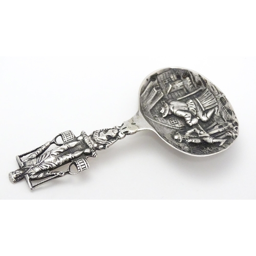 245 - A Continental silver caddy spoon with Dutch style detail. Approx. 3