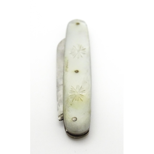 253 - A small silver folding fruit knife with mother of pearl handle having engraved decoration, hallmarke... 