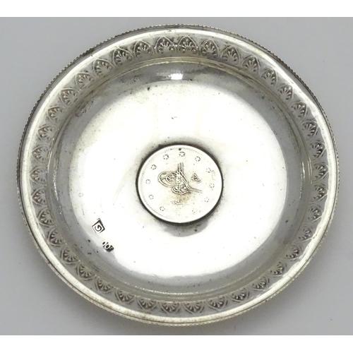 279 - A .800 silver / white metal pin dish of circular form with Ottoman coin style detail to centre. Appr... 