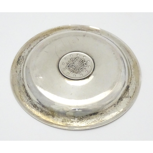 279 - A .800 silver / white metal pin dish of circular form with Ottoman coin style detail to centre. Appr... 