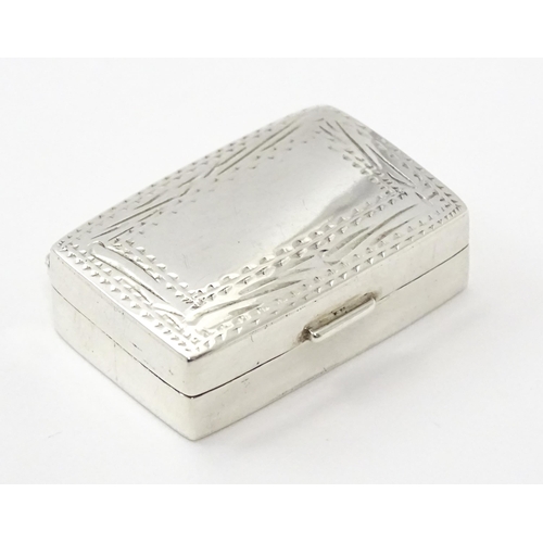 360 - A silver pill box with engraved decoration. Approx.  1 1/4