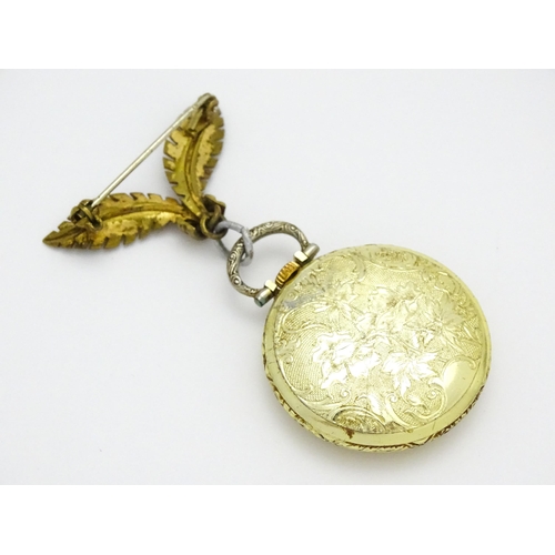 799 - An Ingersoll fob watch with floral decoration to case and with a gilt metal hanger. The watch 1 1/4