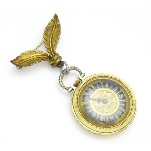 799 - An Ingersoll fob watch with floral decoration to case and with a gilt metal hanger. The watch 1 1/4