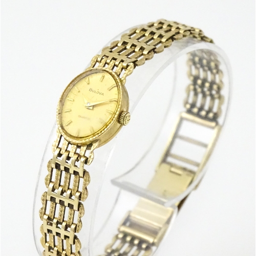 810 - A ladies 9ct gold cased Bulova wristwatch with 9ct gold strap. Approx 12