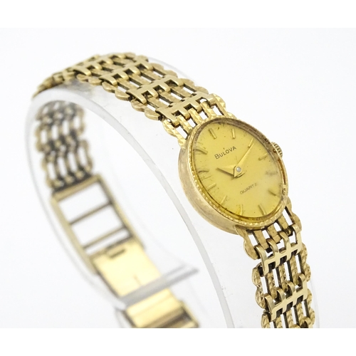 810 - A ladies 9ct gold cased Bulova wristwatch with 9ct gold strap. Approx 12