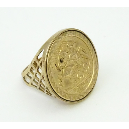 826 - A 9ct gold ring with set with gilt metal St George Medal style detail.