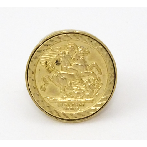 826 - A 9ct gold ring with set with gilt metal St George Medal style detail.