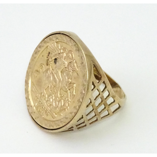 826 - A 9ct gold ring with set with gilt metal St George Medal style detail.