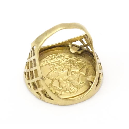 826 - A 9ct gold ring with set with gilt metal St George Medal style detail.