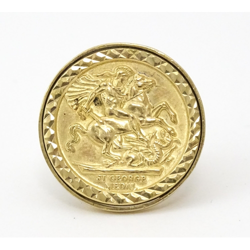 826 - A 9ct gold ring with set with gilt metal St George Medal style detail.