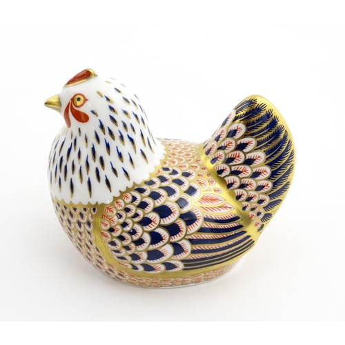 116 - A Royal Crown Derby paperweight modelled as a chicken. Marked under. Boxed. Approx. 4