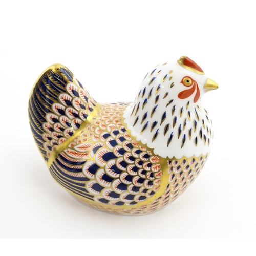 116 - A Royal Crown Derby paperweight modelled as a chicken. Marked under. Boxed. Approx. 4