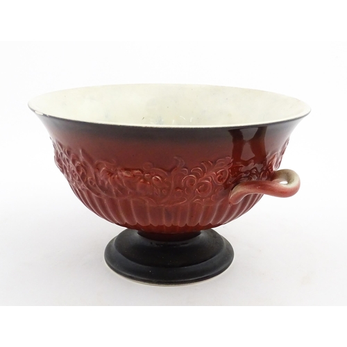 139 - A Carlton Ware pedestal bowl with twin handled and relief foliate detail. Marked under Rouge Royale.... 