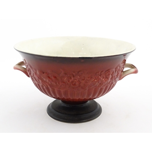 139 - A Carlton Ware pedestal bowl with twin handled and relief foliate detail. Marked under Rouge Royale.... 