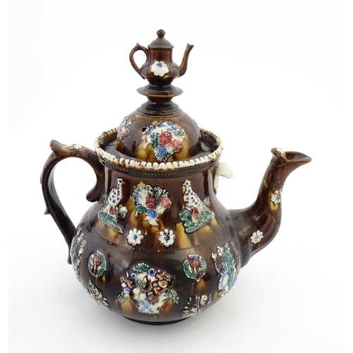 143 - A large 19thC Measham bargeware teapot bearing a plaque with the motto A Present for a Friend, decor... 