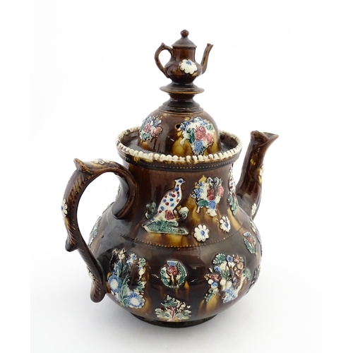 143 - A large 19thC Measham bargeware teapot bearing a plaque with the motto A Present for a Friend, decor... 