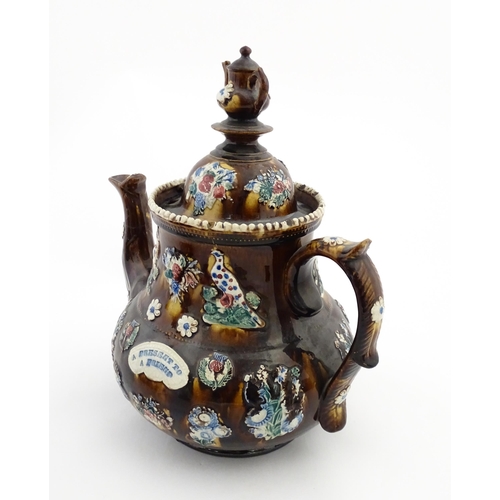 143 - A large 19thC Measham bargeware teapot bearing a plaque with the motto A Present for a Friend, decor... 