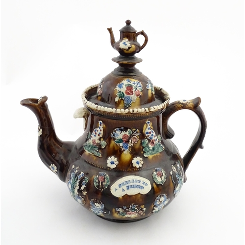 143 - A large 19thC Measham bargeware teapot bearing a plaque with the motto A Present for a Friend, decor... 