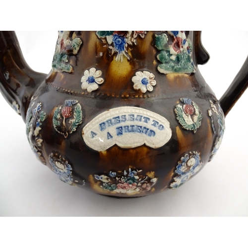 143 - A large 19thC Measham bargeware teapot bearing a plaque with the motto A Present for a Friend, decor... 