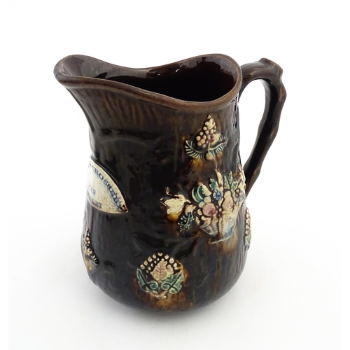 144 - A large 19thC Measham bargeware jug bearing a plaque for Mary A. Crosseby 1882 Mossleym decorated wi... 