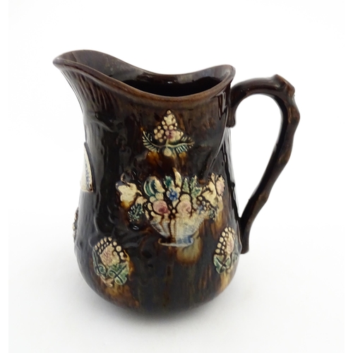 144 - A large 19thC Measham bargeware jug bearing a plaque for Mary A. Crosseby 1882 Mossleym decorated wi... 