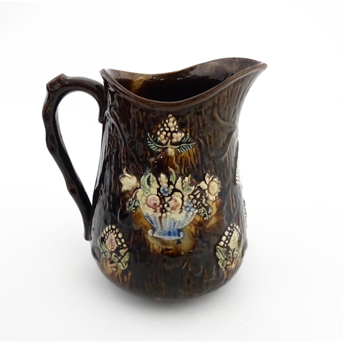 144 - A large 19thC Measham bargeware jug bearing a plaque for Mary A. Crosseby 1882 Mossleym decorated wi... 