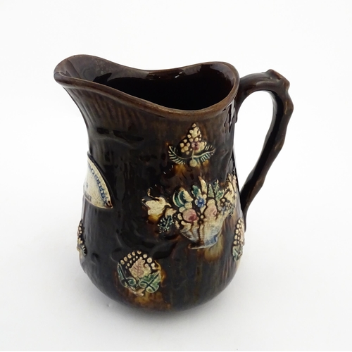 144 - A large 19thC Measham bargeware jug bearing a plaque for Mary A. Crosseby 1882 Mossleym decorated wi... 