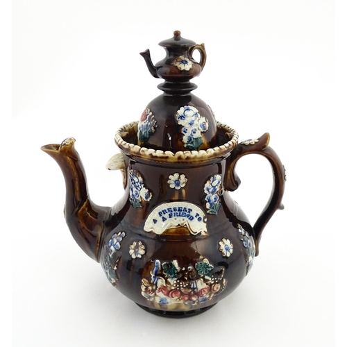 145 - A large 19thC Measham bargeware teapot bearing a plaque with the motto A Present for a Friend, decor... 