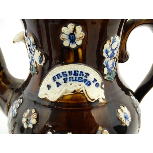 145 - A large 19thC Measham bargeware teapot bearing a plaque with the motto A Present for a Friend, decor... 