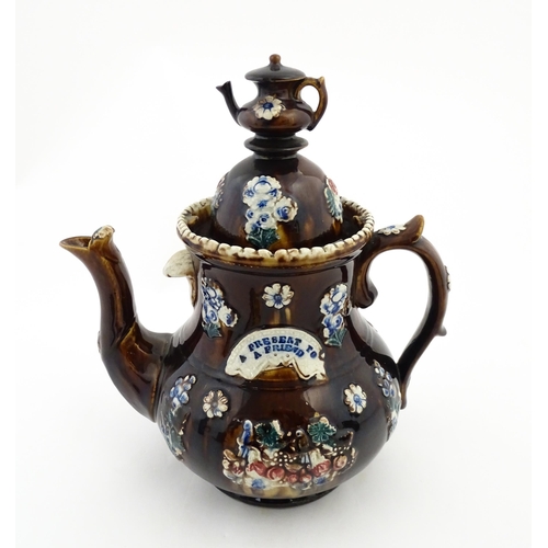 145 - A large 19thC Measham bargeware teapot bearing a plaque with the motto A Present for a Friend, decor... 